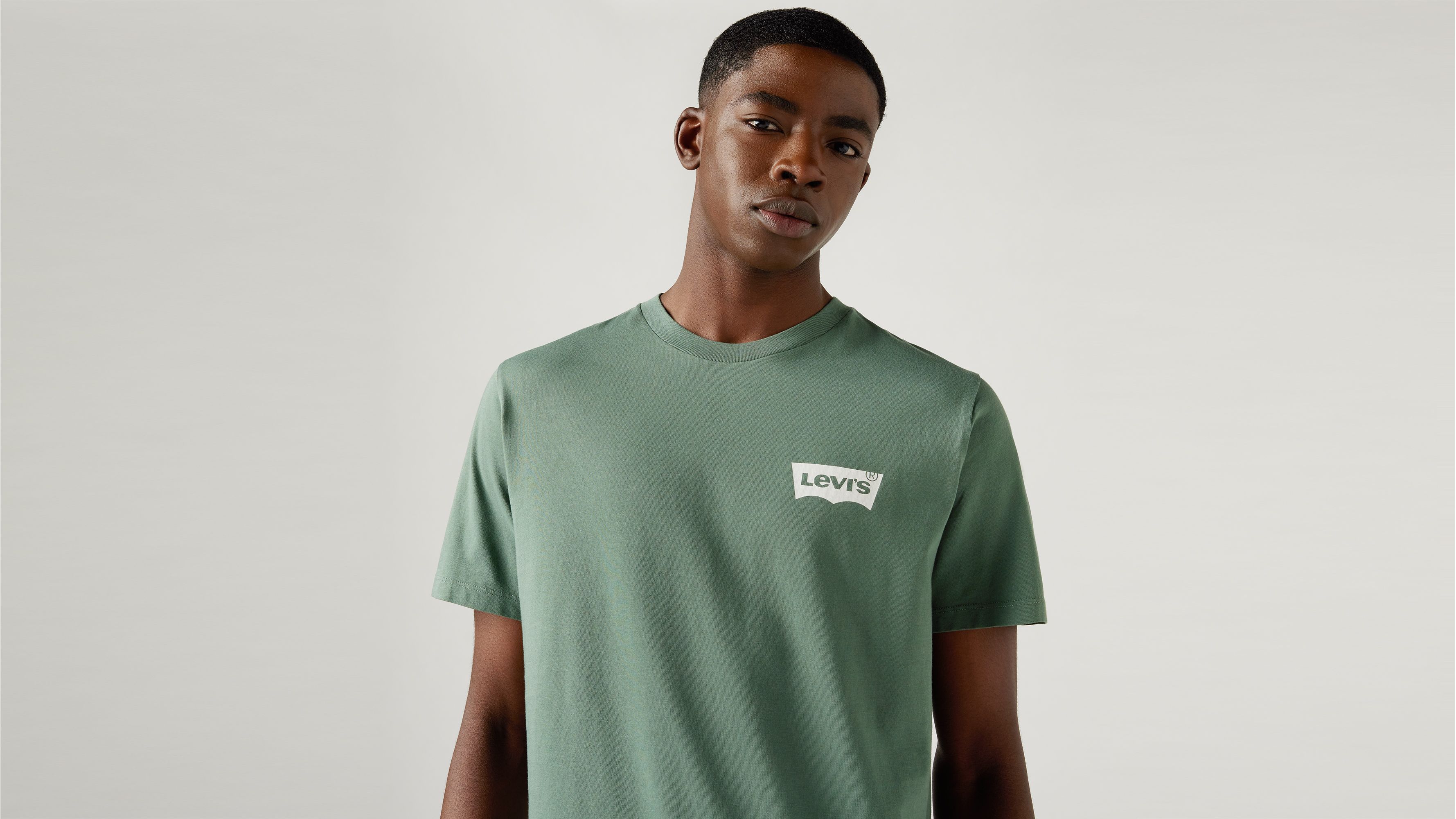 white and dark green graphic tee